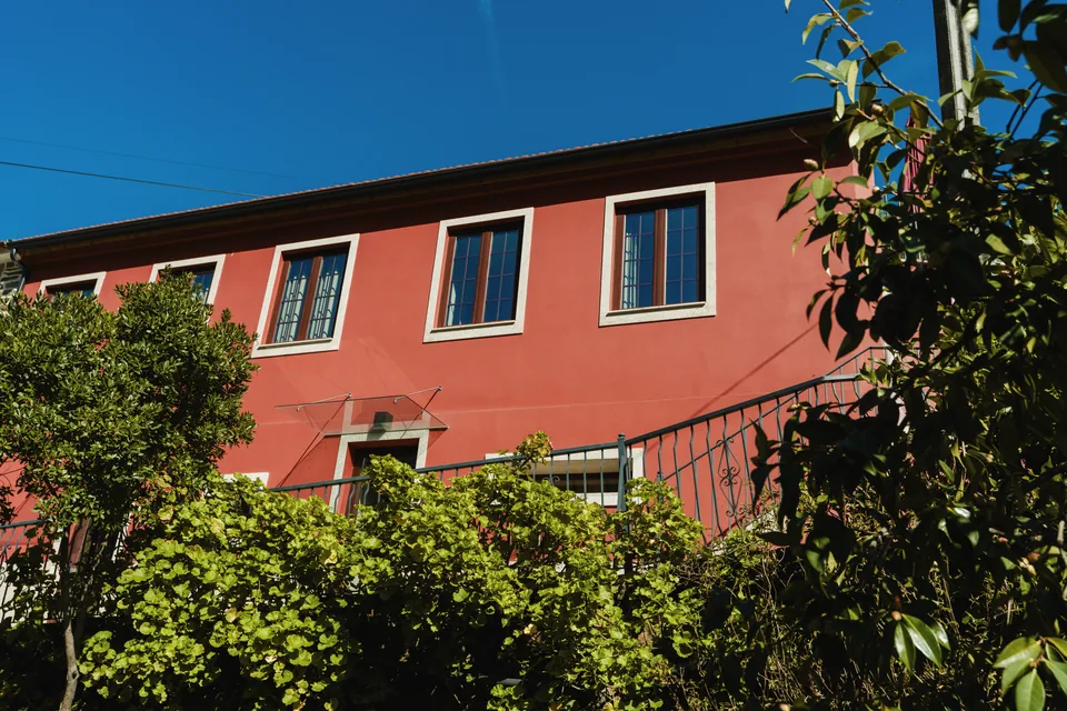 Front facade framed by greenery and blue sky