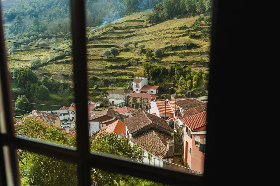 View through Bedroom 1 window towards village roofs and terraced hillside