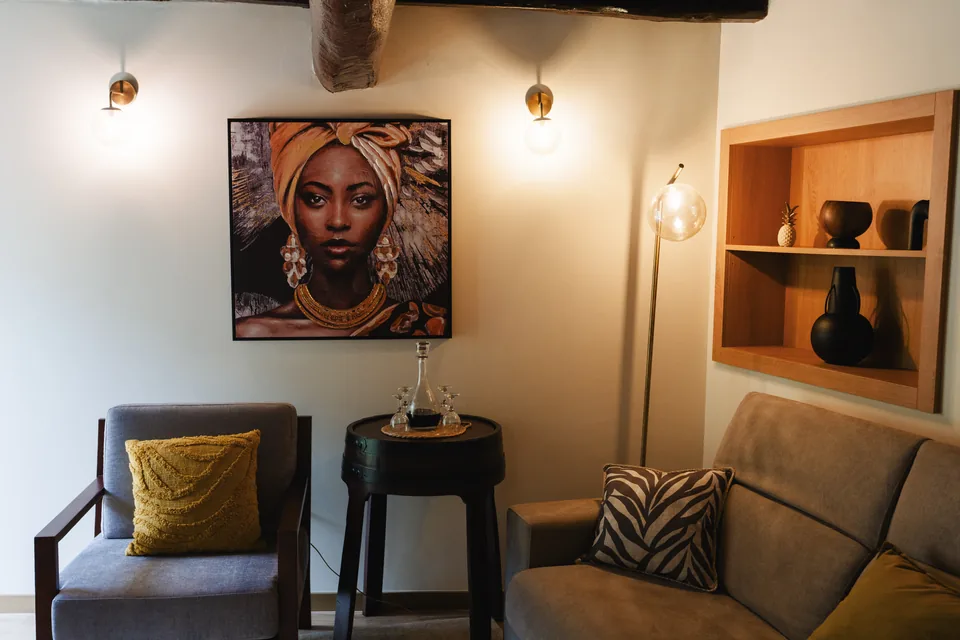 Sitting corner with artwork and sofa under timber beams